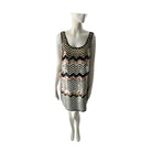 Mannequin wearing a sleeveless dress with a black and gold zigzag pattern on a white background