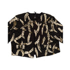 Black top with gold sequin patterns on a white background