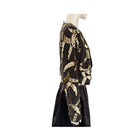 Mannequin wearing a black and gold patterned outfit on a white background