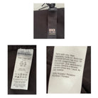 Clothing tags with River Island branding and washing instructions on a black background