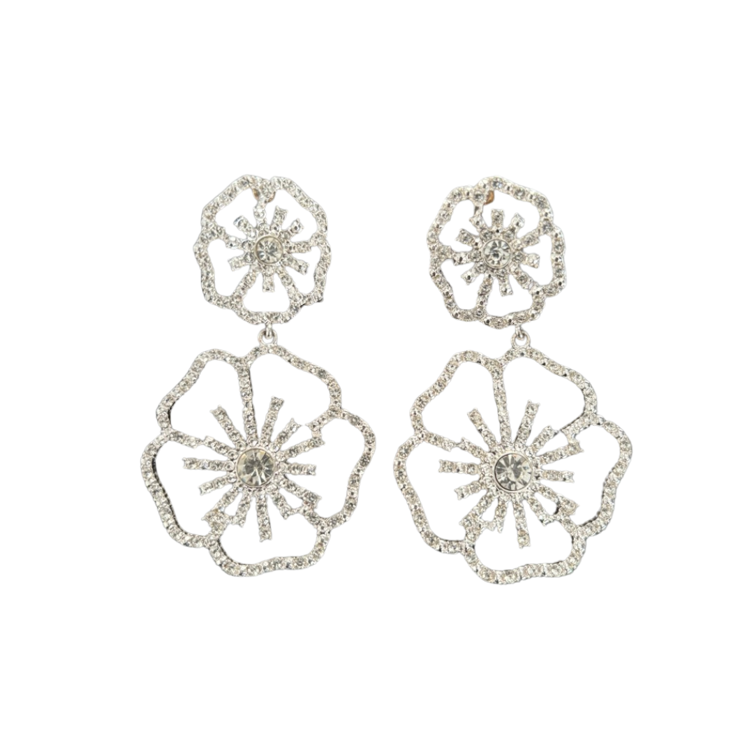 Pair of silver floral earrings on a white background