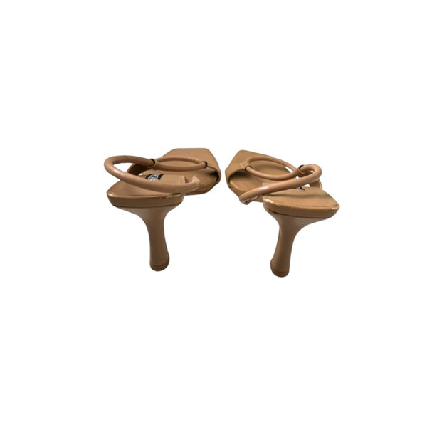 Pair of tan sandals on a white background