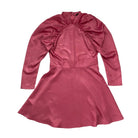Pink satin dress with long sleeves on a white background