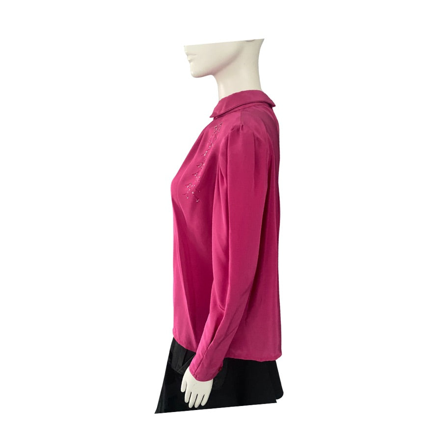 Mannequin wearing a pink shirt with a black bottom section on a white background