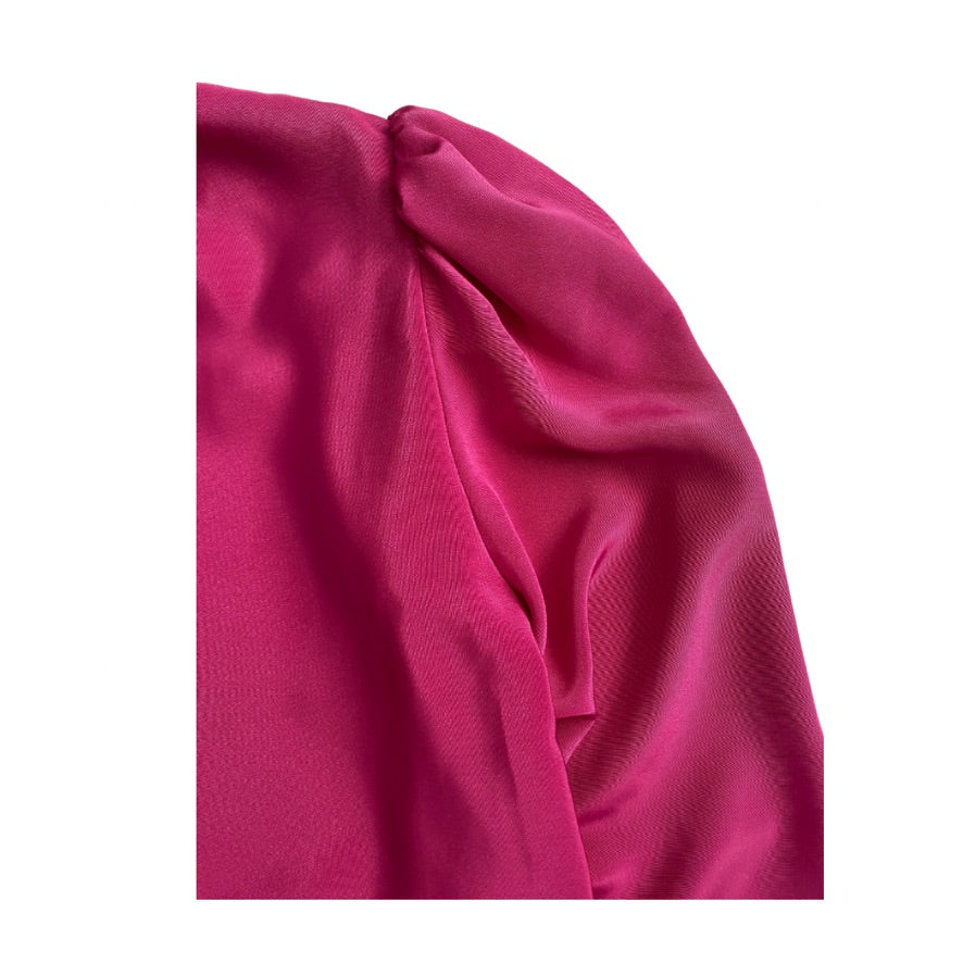 Close-up of blouse shoulder bright pink on a white background