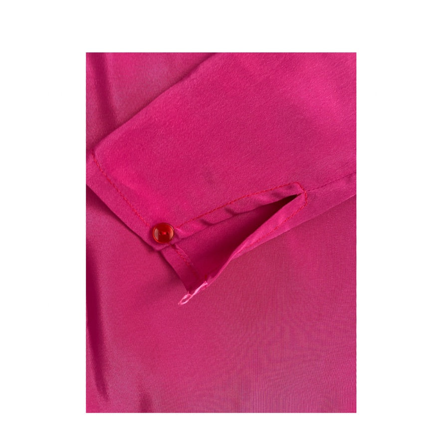 Close-up of a pink shirt with a button on a white background