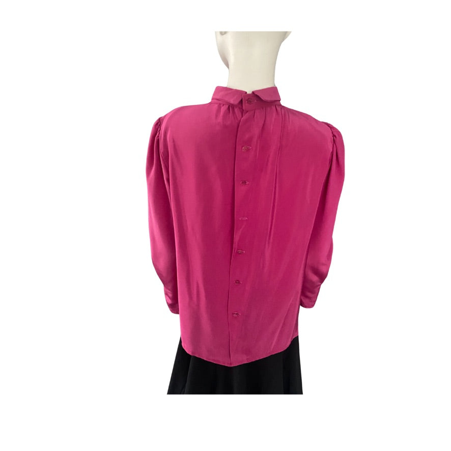 Pink blouse on a mannequin against a white background