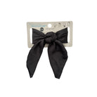 Black hair bow on a Primark branded card against a white background