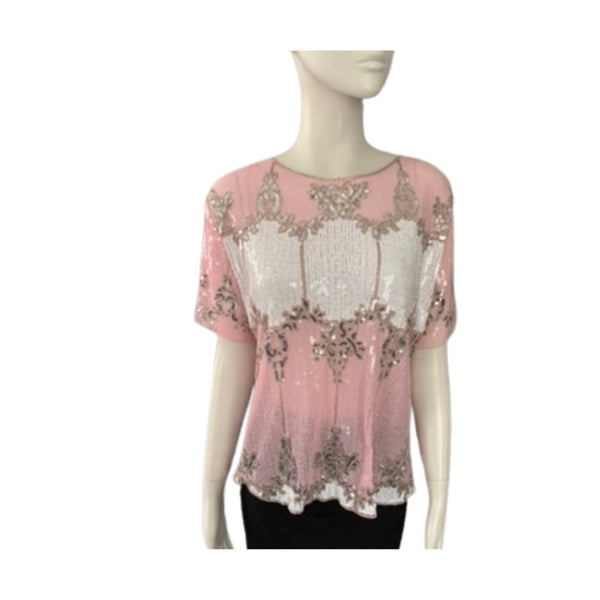 Pink top with floral embroidery on a mannequin against a white background