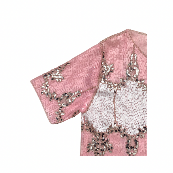 Pink top fabric with intricate silver embroidery on a white background