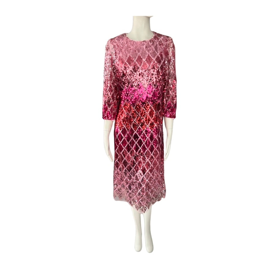 Mannequin wearing a pink and red patterned dress on a white background