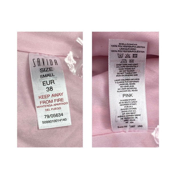 Two clothing labels on a pink fabric background, one showing size and care instructions, the other showing color information.