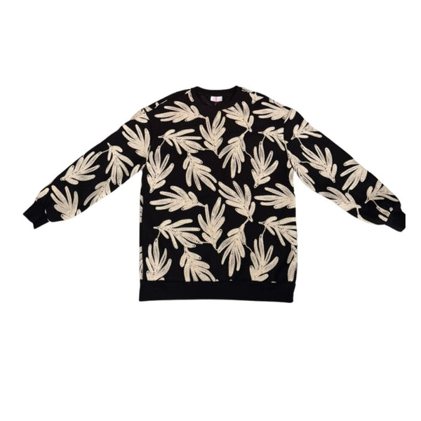 Black sweater with beige leaf pattern on a white background