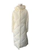Cream quilted puffer coat on a mannequin against a white background