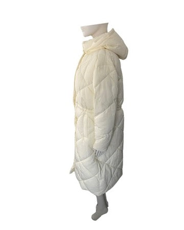 Cream quilted coat on a mannequin against a white background