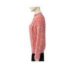 Mannequin wearing a pink chunky knit sweater on a white background