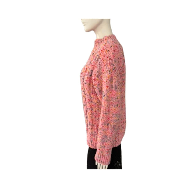 Mannequin wearing a pink chunky knit sweater on a white background