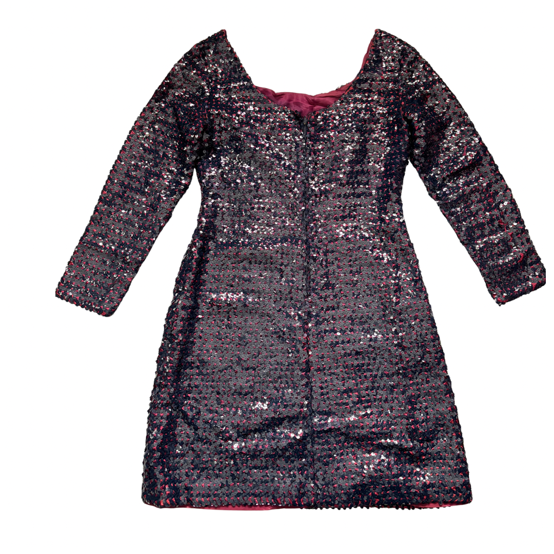 Black sequined dress with a red lining on a white background
