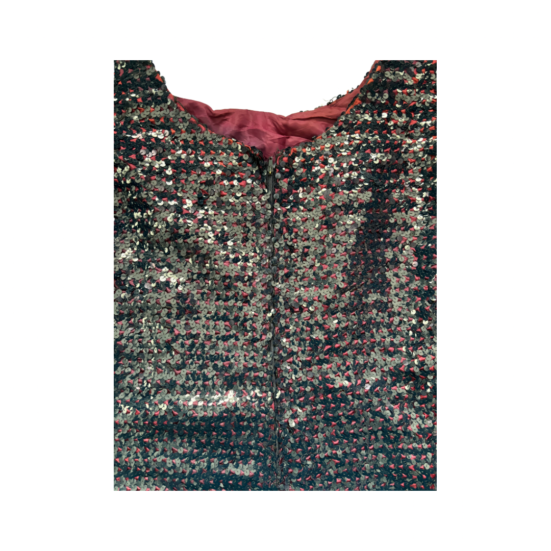 Sequined fabric with a pattern of multicolored sequins on a white background