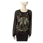 Black sequin top on a mannequin against a white background