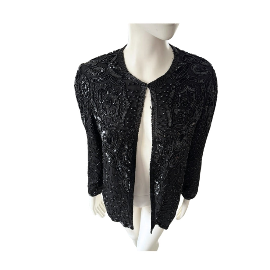 Black beaded jacket on a mannequin against a white background