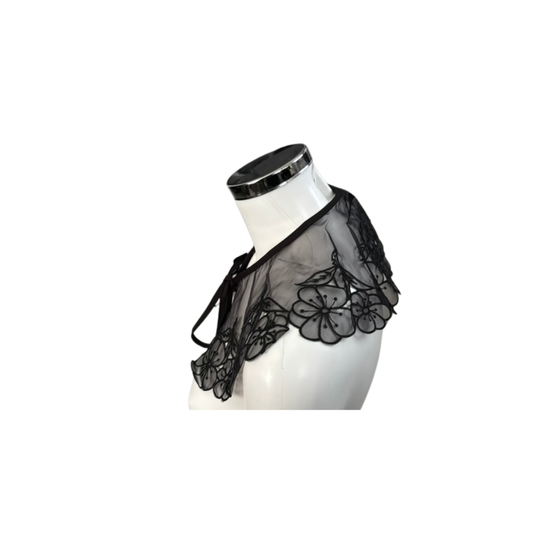 Black lace collar on a mannequin against a white background