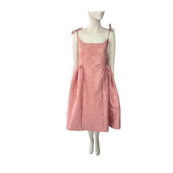 Pink dress on a mannequin against a white background