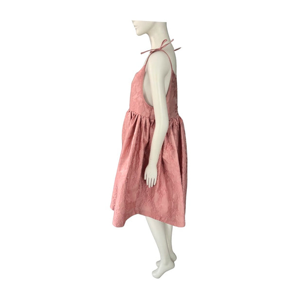 Mannequin wearing a pink dress on a white background