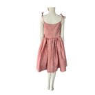 Pink dress on a mannequin against a white background