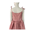 Pink dress on a mannequin against a white background