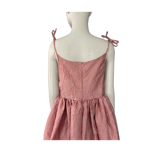 Pink dress on a mannequin against a white background