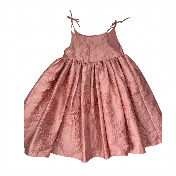 Pink dress with lace details on a white background