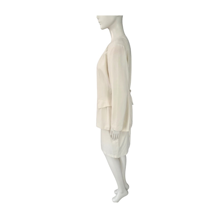Mannequin wearing a cream skirt suit on a white background