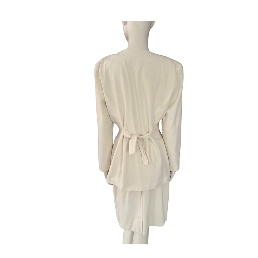 Mannequin wearing a cream-colored suit with a belt on a white background