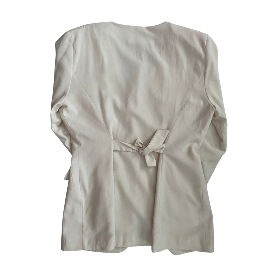 Cream blazer back with a tie detail on a white background