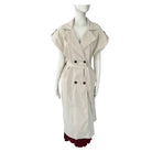 Beige sleeveless trench coat on a mannequin against a white background
