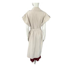 Beige dress with maroon hem on a mannequin against a white background