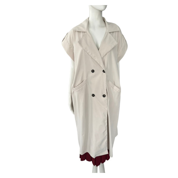 Beige sleeveless coat with black buttons on a mannequin against a white background