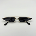 Gold-framed sunglasses with black lenses on a white background