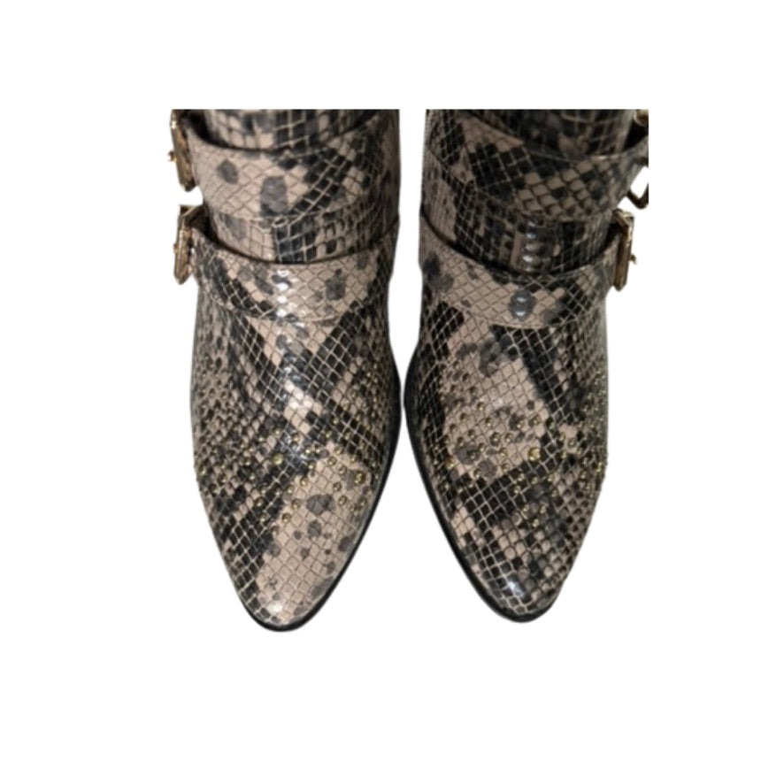 Snakeskin-patterned boots on a white background