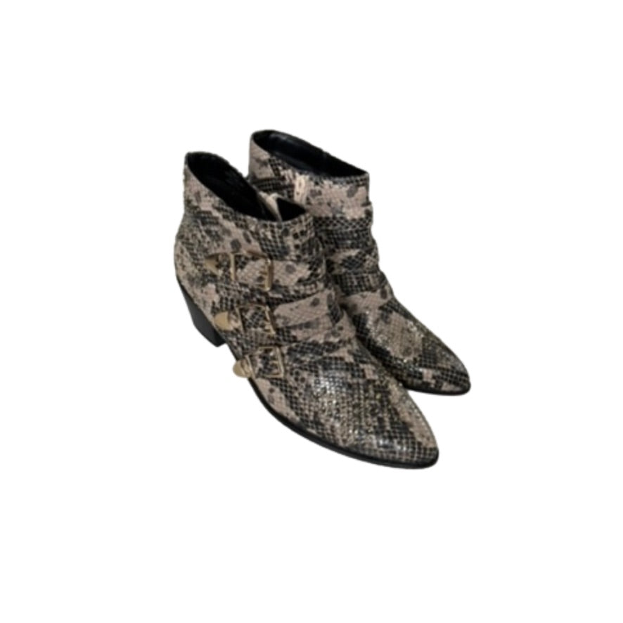 Pair of snake print ankle boots on a white background