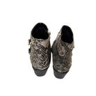 Pair of snake print boots on a white background