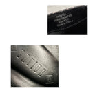 Close-up of a textured surface with branding and text, including 'Saucony' logo.