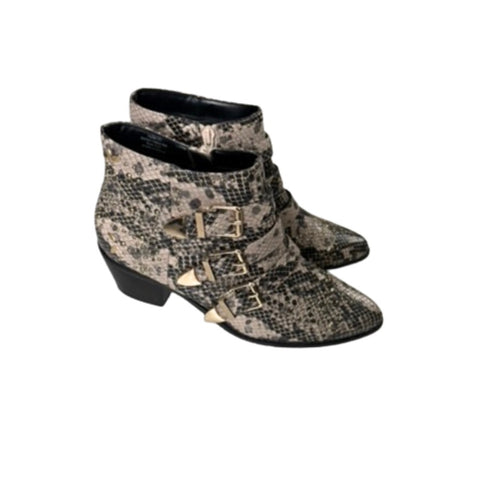Pair of snakeskin-patterned boots with buckles on a white background