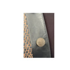 Close-up of a textured fabric surface with a decorative button.