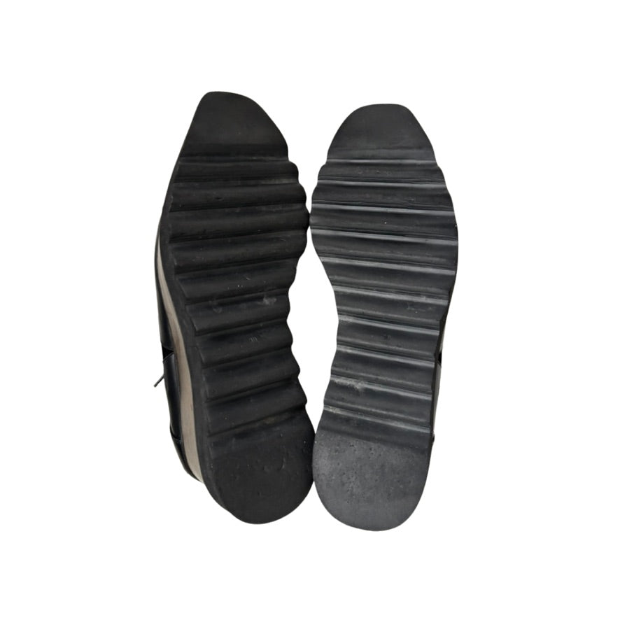 Black shoe soles on a white background