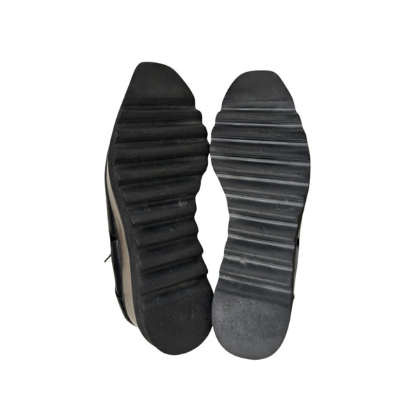 Black shoe soles on a white background