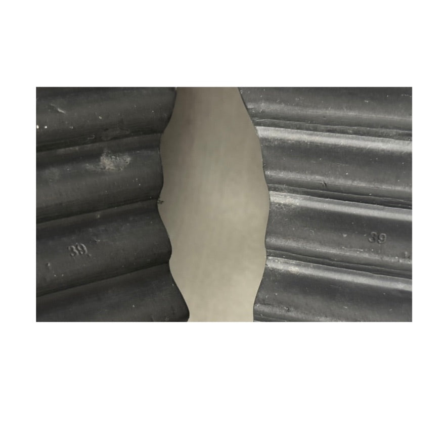 Close-up of a corrugated metal surface with a white border