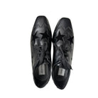 Pair of black shoes with star designs on a white background