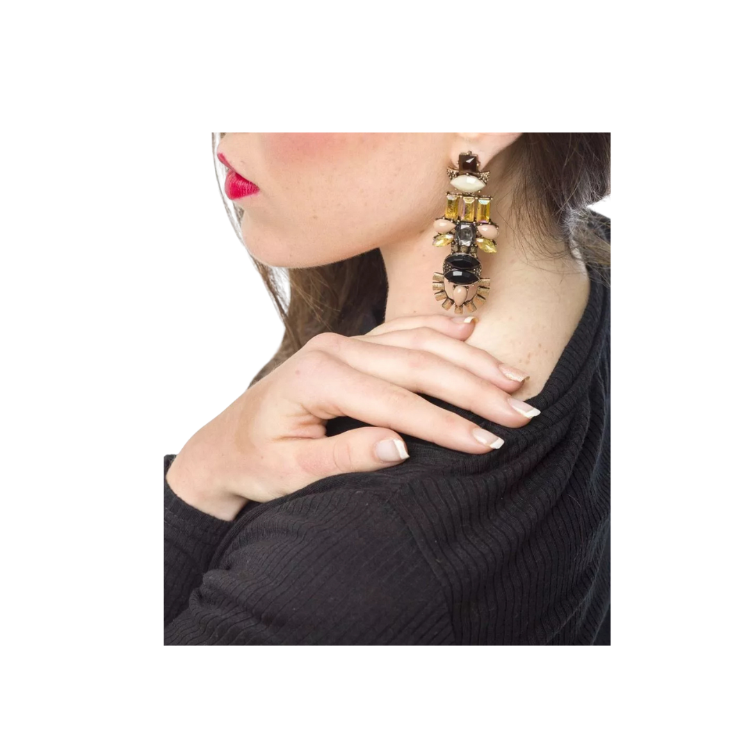 Close-up of a woman wearing a decorative earring with a white background